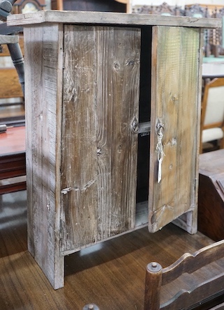 A small provincial pine two door cabinet